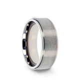 Titanium men's wedding ring with raised, brushed center and polished step edges.